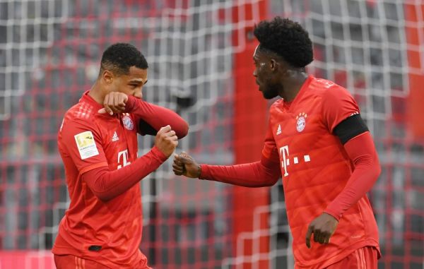 23 May 2020, Bavaria, Munich: Football: Bundesliga, 27th matchday, FC Bayern Munich - Eintracht Frankfurt, in the Allianz Arena. Serge Gnabry and Alphonso Davies (r) of Bayern cheer about the goal for the 5:2. PHOTO | AFP