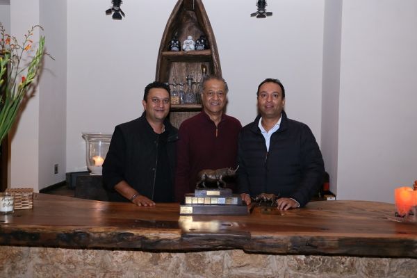   Manee Choda (in the middle) celebrates the Spirit Of The Charge Award trophy with his sons Sandev (left) and Sachin after being honoured by Rhino Charge officials for his bravery and 30-year commitment to the initiative, whose mission is to conserve Kenya’s forests and water towers, in Nairobi on June 29, 2019.PHOTO/ ANTONY MWAKI