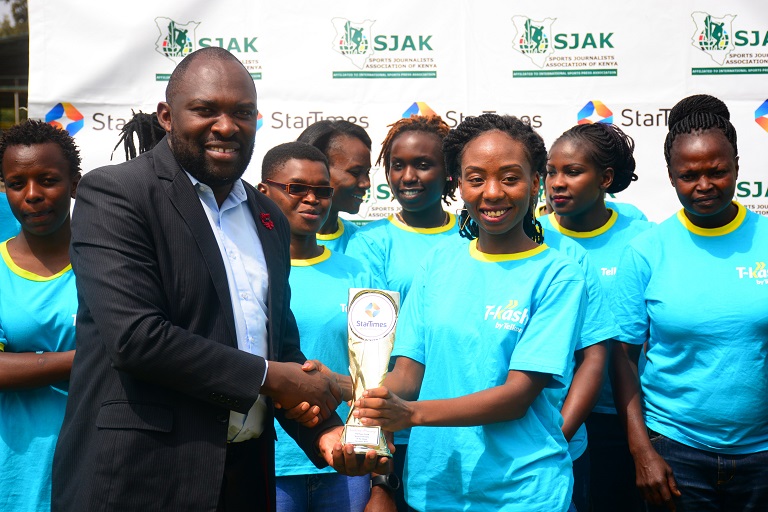   Telkom hokey captain Tracy Karanja receives the Sports personality award on behalf of Jackie Mwangi from Startimes Marketing Director Japheth Akhulia at City Park stadium in Nairobi on January 23, 2018.PHOTO/SPN