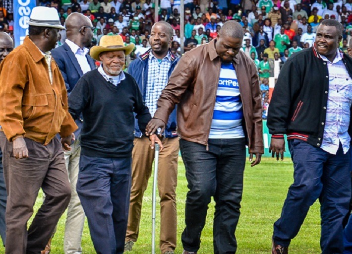  Football legend Joe Kadenge (2nd L) is flanked by former Prime Minister, Raila Amolo Odinga (left) and Nairobi Senator, Johnson Sakaja (3rd left) upon arrival for the Hull City Challenge Mashemeji Derby between Gor Mahia FC and AFC Leopards SC on May 1, 2018 at the Afraha Stadium, Nakuru. PHOTO/Trizah Akoth
