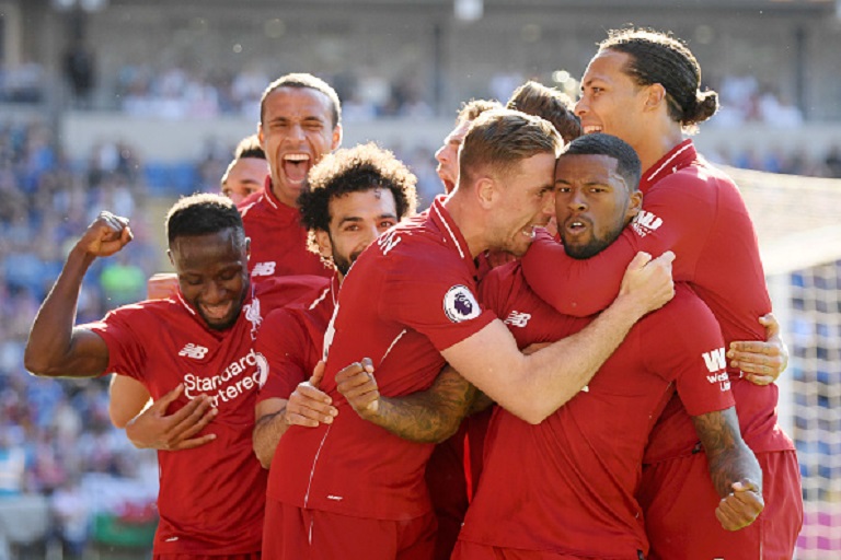  Georginio Wijnaldum of Liverpool celebrates as he scores his team's first goal with Jordan Henderson and team mates during the Premier League match between Cardiff City and Liverpool FC at Cardiff City Stadium on April 21, 2019 in Cardiff, United Kingdom. PHOTO/GETTY IMAGES