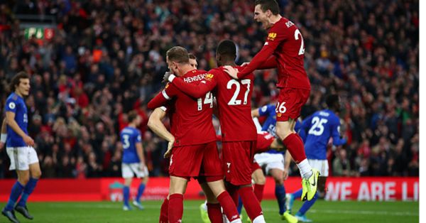  James Milner of Liverpool celebrates with Jordan Henderson of Liverpool and Divock Origi of Liverpool and Andy Robertson of Liverpool after he scores his sides second goal from the penalty spot during the Premier League match between Liverpool FC and Leicester City at Anfield on October 05, 2019 in Liverpool, United Kingdom. PHOTO/ GETTY IMAGES