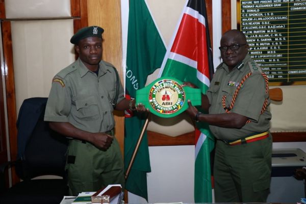  Rayton 'Boom Boom' Okwiri  when he presented the coveted ABU belt to Kenya Prisons Service Commissioner General Wycliffe Ogallo in Nairobi on June 27, 2019. PHOTO/ KPS