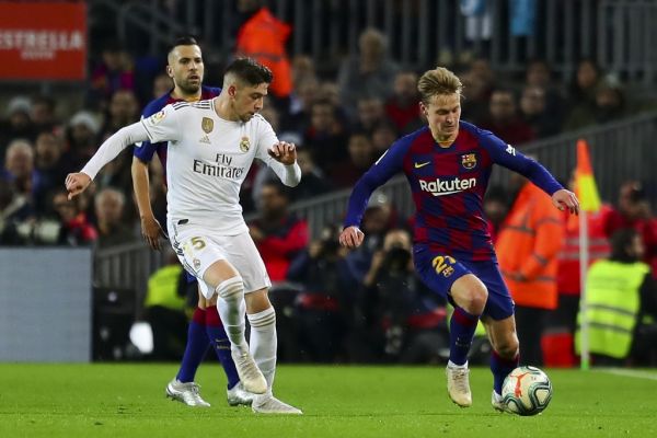Real Madrid's Brazilian Forward Vinicius Junior (Front L) vies with Barcelona's Dutch midfielder Frekie De Jong (R) during Spanish El Clasico football match between FC Barcelona and Real Madrid at the Camp Nou stadium in Barcelona on December 18, 2019. PHOTO | AFP