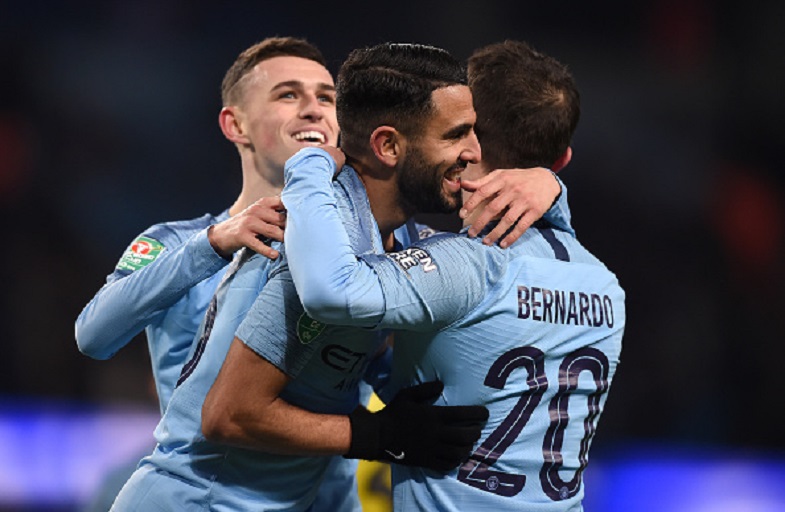  Riyad Mahrez of Manchester City celebrates with Bernardo Silva and Phil Foden as he scores his team's ninth goal during the Carabao Cup Semi Final First Leg match between Manchester City and Burton Albion at Etihad Stadium on January 9, 2019 in Manchester, United Kingdom. PHOTO/GETTY IMAGES