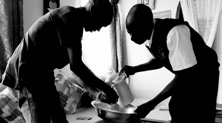 A restaurant waiter serves Olympic marathon champion and world record holder, Eliud Kipchoge (left) before he sat down for lunch with the SportPesa News journalists in Eldoret for the A Day In Life With feature on October 9, 2018. PHOTO/SPN