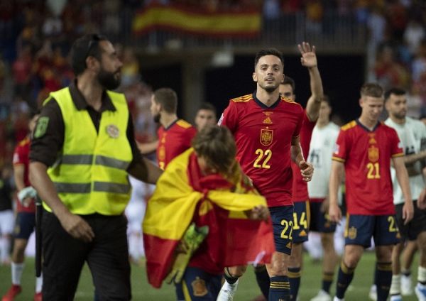 A security guard escorts a boy who entered the field as Spanish striker Pablo Sarabia approaches to allow the kid to join the rest of the players at the end of the UEFA Nations League, group 2 football match of the league A between Spain and the Czech Republic at the La Rosaleda stadium. in Malaga on June 12, 2022. PHOTO | AFP