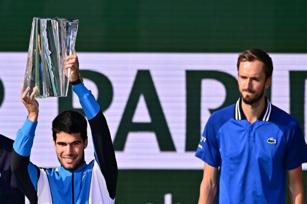 Alcaraz lifts the 2024 Indian Wells title with Medvedev watching. PHOTO| AFP