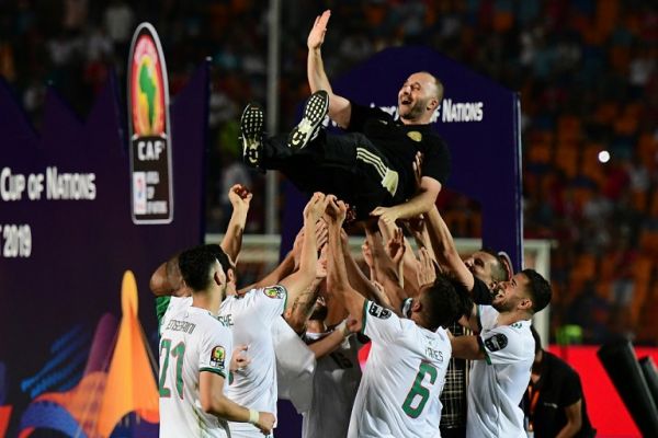 Algerian players make Algeria's coach Djamel Belmadi jump celebrate after winning the 2019 Africa Cup of Nations (CAN) Final football match between Senegal and Algeria at the Cairo International Stadium in Cairo on July 19, 2019. PHOTO | AFP