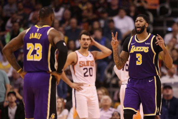 Anthony Davis #3 and LeBron James #23 of the Los Angeles Lakers talk during the second half of the NBA game against the Phoenix Suns at Talking Stick Resort Arena on November 12, 2019 in Phoenix, Arizona. The Lakers defeated the Suns 123-115. PHOTO | AFP