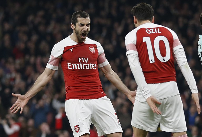 Arsenal's Armenian midfielder Henrikh Mkhitaryan (L) celebrates scoring his team's second goal with Arsenal's German midfielder Mesut Ozil during the English Premier League football match between Arsenal and Bournemouth at the Emirates Stadium in London on February 27, 2019. PHOTO/AFP