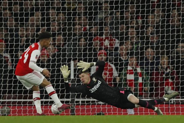 Arsenal's English midfielder Reiss Nelson (L) shoots past Leeds United's French goalkeeper Illan Meslier (R) to score the opening goal of the English FA Cup third round football match between Arsenal and Leeds United at The Emirates Stadium in London on January 6, 2020. PHOTO | AFP