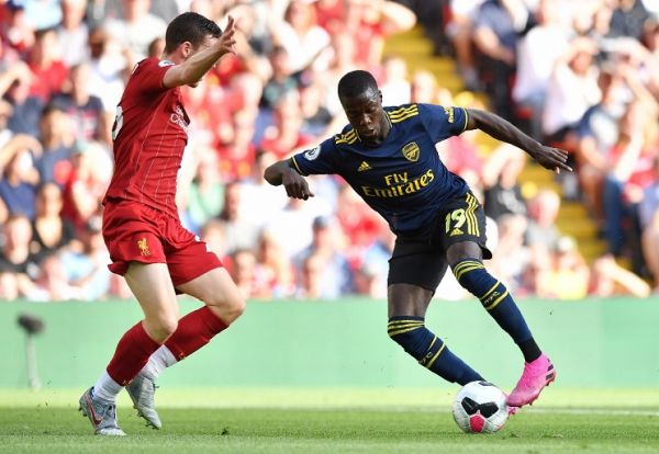 Arsenal's French-born Ivorian midfielder Nicolas Pepe (R) controls the ball in front of Liverpool's Scottish defender Andrew Robertson (L) during the English Premier League football match between Liverpool and Arsenal at Anfield in Liverpool, north west England on August 24, 2019. PHOTO | AFP