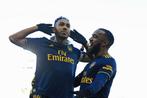 Arsenal's Gabonese striker Pierre-Emerick Aubameyang (L) celebrates with Arsenal's French striker Alexandre Lacazette (R) after scoring their first goal from the penalty spot during the English Premier League football match between Norwich City and Arsenal at Carrow Road in Norwich, eastern England on December 1, 2019. PHOTO | AFP