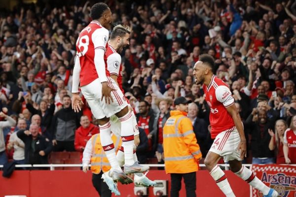 Arsenal's Gabonese striker Pierre-Emerick Aubameyang (R) celebrates with teammates after scoring their third goal during the English Premier League football match between Arsenal and Aston Villa at the Emirates Stadium in London on September 22, 2019. PHOTO | AFP