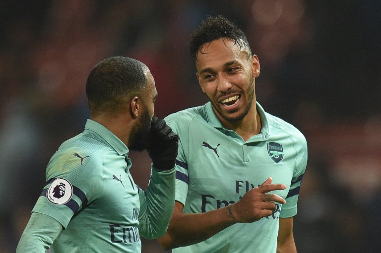 Arsenal's Gabonese striker Pierre-Emerick Aubameyang (R) talks with Arsenal's French striker Alexandre Lacazette (L) at the end of the English Premier League football match between Manchester United and Arsenal at Old Trafford in Manchester, north west England, on December 5, 2018. PHOTO/AFP