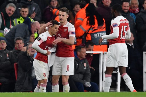 Arsenal's Uruguayan midfielder Lucas Torreira (L) celebrates with Arsenal's Welsh midfielder Aaron Ramsey after scoring the team's second goal during the UEFA Europa League quarter final, first leg, football match between Arsenal and Napoli at the Emirates Stadium in London on April 11, 2019. PHOTO/AFP