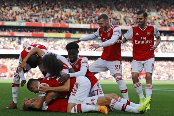 Asenal's Brazilian defender David Luiz (C) celebrates with teammates after scoring the opening goal of the English Premier League football match between Arsenal and Bournemouth at the Emirates Stadium in London on October 6, 2019. PHOTO | AFP