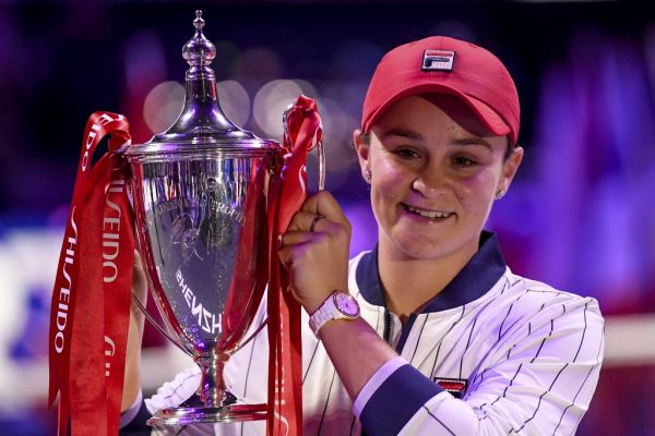 Ashleigh Barty of Australia (C) raises her trophy after winning against Elina Svitolina of Ukraine in their women's singles in the WTA Finals tennis tournament in Shenzhen on November 3, 2019. PHOTO | AFP