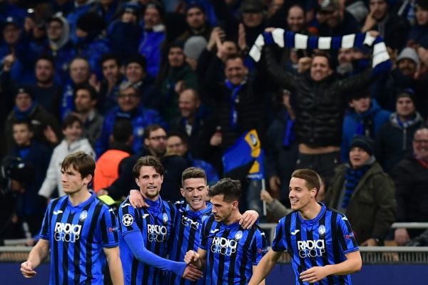 Atalanta's Swiss midfielder Remo Freuler (2ndR) celebrates with teammates Atalanta's Dutch defender Hans Hateboer (2ndL) after scoring during the UEFA Champions League round of 16 first leg football match Atalanta Bergamo vs Valencia on February 19, 2020 at the San Siro stadium in Milan. PHOTO | AFP