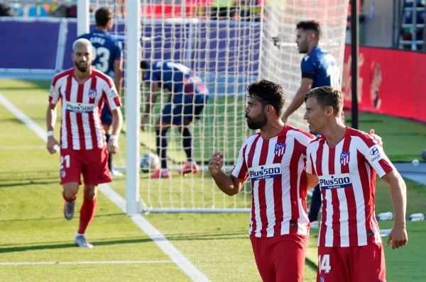 Atletico Madrid's Spanish forward Diego Costa (C) celebrates with Atletico Madrid's Spanish midfielder Marcos Llorente after scoring during the Spanish league football match Levante UD against Club Atletico de Madrid at the Camilo Cano stadium in La Nucia on June 23, 2020. PHOTO | AFP