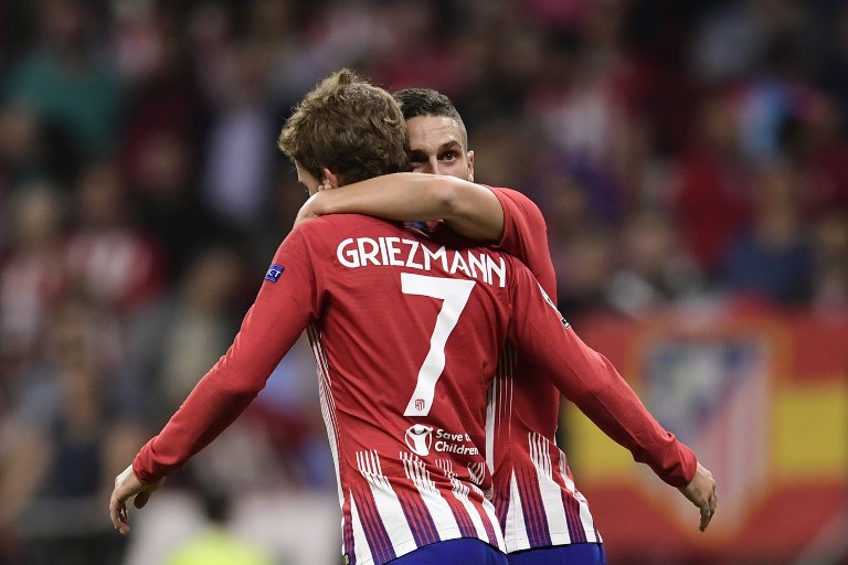 Atletico Madrid's Spanish midfielder Koke (R) celebrates with Atletico Madrid's French forward Antoine Griezmann after scoring during the UEFA Champions League group A football match between Club Atletico de Madrid and Club Brugge at the Wanda Metropolitano stadium in Madrid on October 3, 2018. PHOTO/AFP