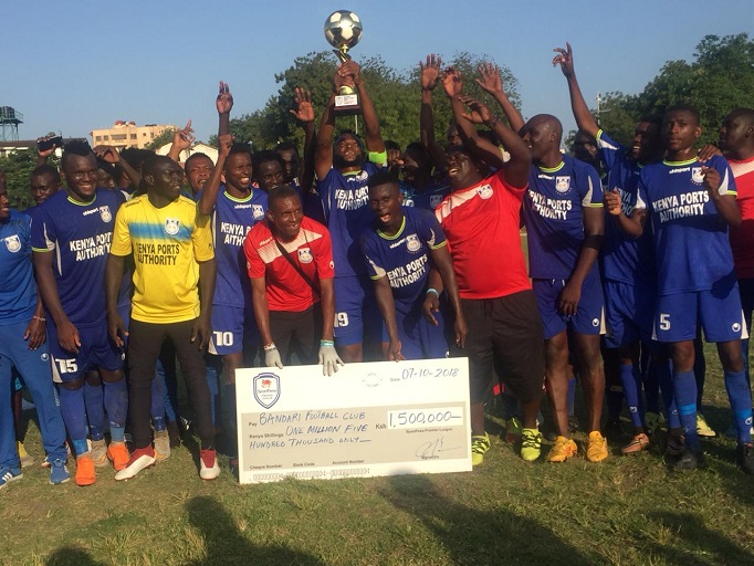 Bandari FC players celebrate with their SportPesa Premier League (SPL) 1st runners-up trophy and winners cheque of KShs 1.5million after their 5-1 victory over Thika United FC on Sunday, October 7 at the Mbaraki Sports Club. PHOTO/SPN