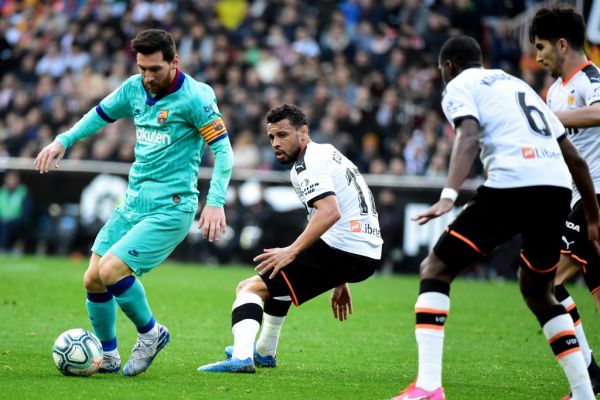 Barcelona's Argentine forward Lionel Messi (L) controls the ball next to Valencia's French midfielder Francis Coquelin during the Spanish league football match Valencia CF against FC Barcelona at the Mestalla stadium in Valencia on January 25, 2020. PHOTO | AFP