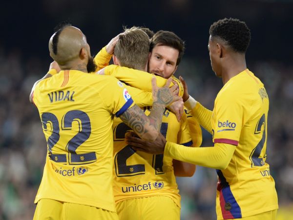 Barcelona's Dutch midfielder Frenkie De Jong (2L) is congratulated by Barcelona's Argentine forward Lionel Messi during the Spanish league football match between Real Betis and FC Barcelona at the Benito Villamarin stadium in Seville on February 9, 2020. PHOTO | AFP