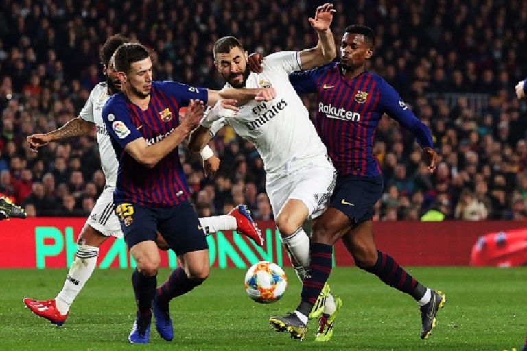 Barcelona's French defender Clement Lenglet, Real Madrid's French forward Karim Benzema and Barcelona's Portuguese defender Nelson Semedo vie for the ball during Spanish Copa del Rey football match between FC Barcelona and Real Madrid at the Camp Nou stadium in Barcelona on February 6, 2019. PHOTO/GettyImages