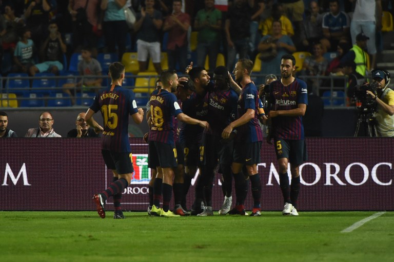 Barcelona's players celebrate with Barcelona's French forward Ousmane Dembele (C) after his goal during the Spanish Super Cup final between Sevilla FC and FC Barcelona at Ibn Batouta Stadium in the Moroccan city of Tangiers on August 12, 2018. PHOTO/AFP