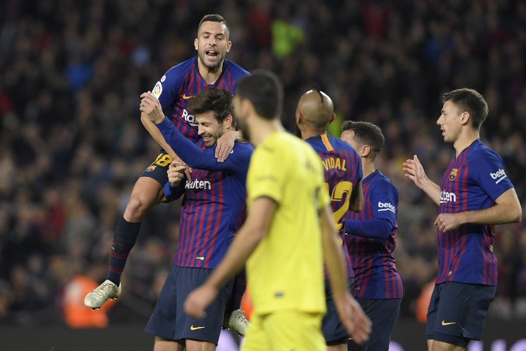 Barcelona's Spanish defender Gerard Pique (2L) celebrates with Barcelona's Spanish defender Jordi Alba after scoring during the Spanish league football match FC Barcelona against Villarreal CF at the Camp Nou stadium in Barcelona on December 2, 2018. PHOTO/AFP