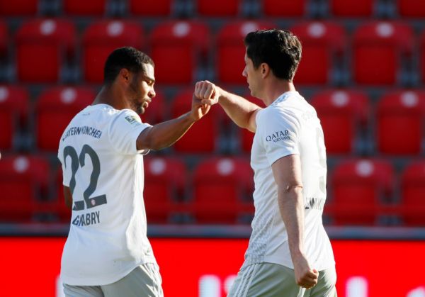 Bayern Munich's Polish forward Robert Lewandowski (R) celebrates scoring the opening goal from the penalty spot with his teammate Bayern Munich's German midfielder Serge Gnabry during the German first division Bundesliga football match FC Union Berlin v FC Bayern Munich on May 17, 2020 in Berlin, Germany as the season resumed following a two-month absence due to the novel coronavirus COVID-19 pandemic. PHOTO | AFP