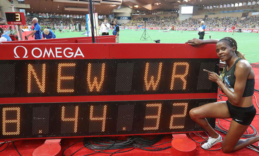 Beatrice Chepkoech poses next to the clock displaying her new world record in the 3000m steeplechase women at the 2018 IAAF Diamond League meeting in Monaco. PHOTO/File