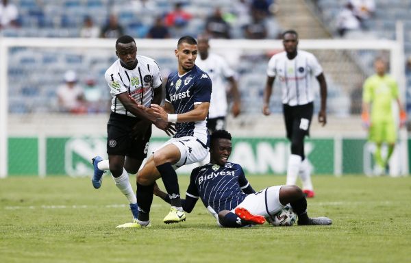 Bidvest Wits' defender Lorenzo Gordinho (C) and Thabang Monare (R) vies for the ball with Orlando Pirates' midfielder Siphesihle Ndlovu during the Nedbank Cup Last 32 football match between Orlando Pirates and Bidvest Wits at the Orlando Stadium in Soweto on February 9, 2020. PHOTO | AFP