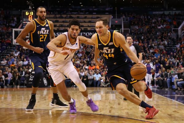 Bojan Bogdanovic #44 of the Utah Jazz drives the ball past Devin Booker #1 of the Phoenix Suns during the second half of the NBA game at Talking Stick Resort Arena on October 28, 2019 in Phoenix, Arizona. The Jazz defeated the Suns 96-95. PHOTO | AFP