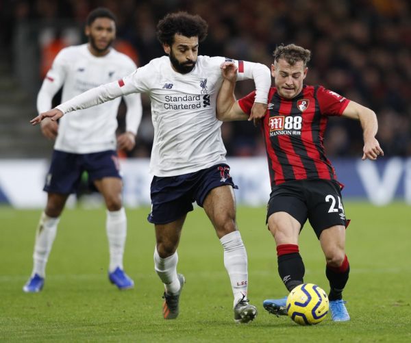 Bournemouth's Scottish midfielder Ryan Fraser (R) holds off Liverpool's Egyptian midfielder Mohamed Salah (L) to play the ball during the English Premier League football match between Bournemouth and Liverpool at the Vitality Stadium in Bournemouth, southern England on December 7, 2019. PHOTO | AFP