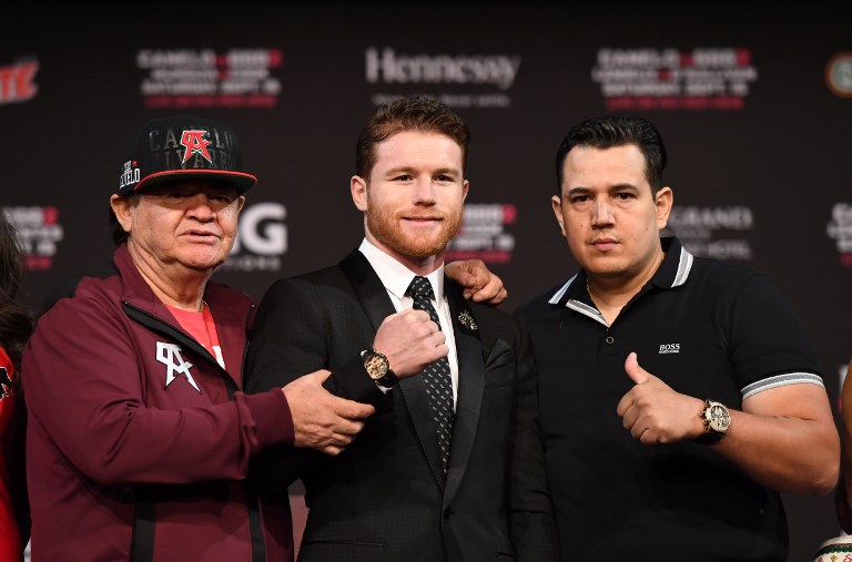 Boxer Canelo Alvarez (C), his manager/trainer Jose "Chepo" Reynoso (L) and trainer Eddy Reynoso (R) pose after a news conference at MGM Grand Hotel & Casino on September 12, 2018 in Las Vegas, Nevada. Alvarez will challenge WBC/WBA middleweight champion Gennady Golovkin for his titles in a rematch on September 15 at T-Mobile Arena in Las Vegas. PHOTO/AFP