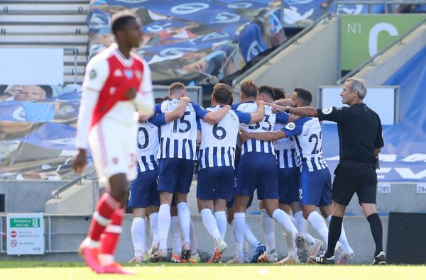 Brighton's French striker Neal Maupay (unseen) celebrates with teammates after scoring his team's second goal during the English Premier League football match between Brighton and Hove Albion and Arsenal at the American Express Community Stadium in Brighton, southern England on June 20, 2020. PHOTO | AFP