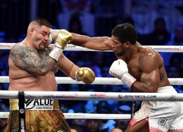 British boxer Anthony Joshua (white trunks) competes with Mexican-American boxer Andy Ruiz Jr (golden trunks) during the heavyweight boxing match between Andy Ruiz Jr. and Anthony Joshua for the IBF, WBA, WBO and IBO titles in Diriya, near the Saudi capital on December 7, 2019. Ruiz seeks to win back the titles that he lost to Ruiz in a shock June defeat in New York in this high-profile duel , dubbed "Clash on the Dunes". PHOTO | AFP