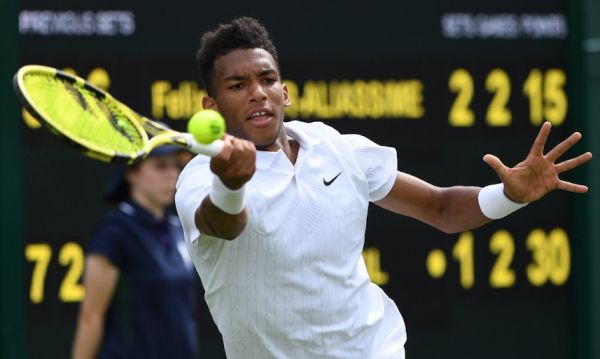 Canada's Felix Auger-Aliassime returns against Canada's Vasek Pospisil during their men's singles first round match on the first day of the 2019 Wimbledon Championships at The All England Lawn Tennis Club in Wimbledon, southwest London, on July 1, 2019. PHOTO/AFP