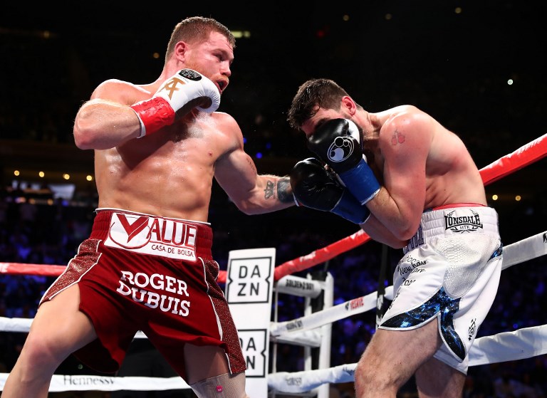 Canelo Alvarez (L) lands a punch against Rocky Fielding (R) during their WBA Super Middleweight title bout at Madison Square Garden on December 15, 2018 in New York City. PHOTO/AFP