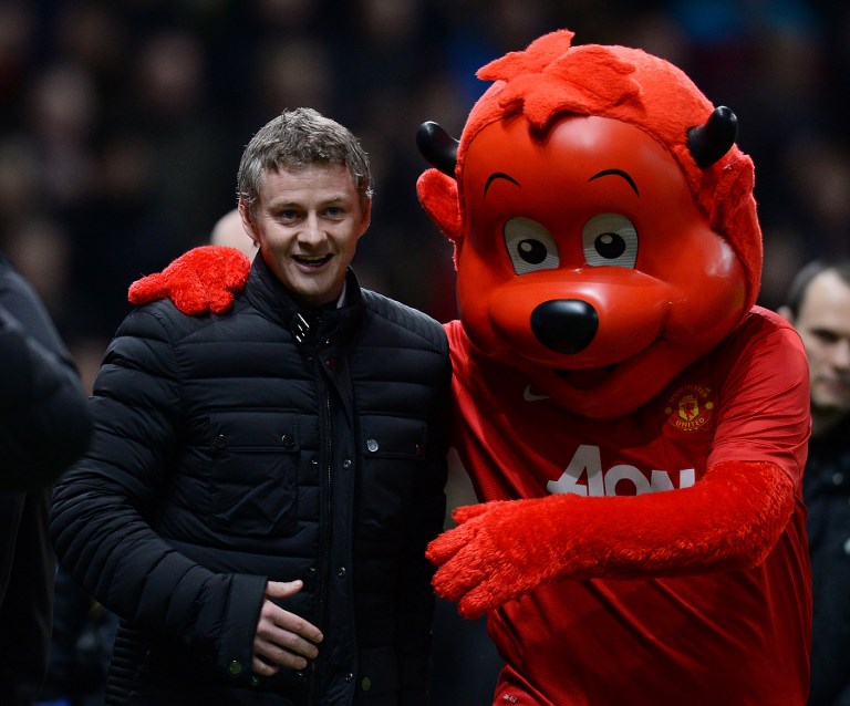 Cardiff City's Norwegian manager Ole Gunnar Solskjaer (L) talks with the Manchester United mascot 'Fred the Red' (R) during the English Premier League football match between Manchester United and Cardiff City at Old Trafford in Manchester, northwest England, on January 28, 2014. PHOTO/AFP