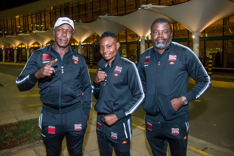 Catherine Phiri (middle) poses with her trainer Michael Zulu (right) and promoter Christopher Malunga (left) soon after arriving at the Jomo Kenyatta International Airport on Tuesday, March 19, 2019. PHOTO/BrianKinyanjui/SPN