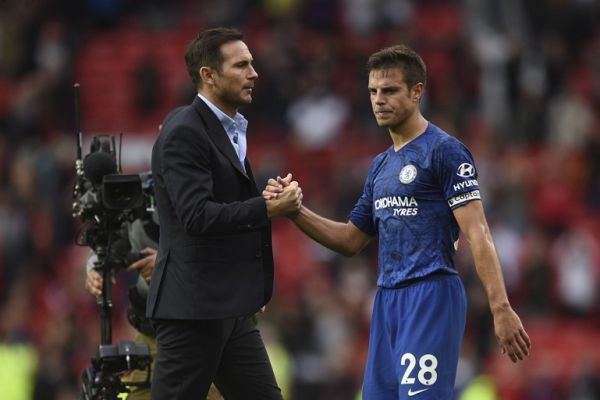 Chelsea's English head coach Frank Lampard (L) shakes hands with Chelsea's Spanish defender Cesar Azpilicueta on the pitch at the final whistle in the English Premier League football match between Manchester United and Chelsea at Old Trafford in Manchester, north west England, on August 11, 2019. Manchester United won the game 4-0. PHOTO | AFP