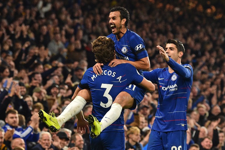 Chelsea's Spanish midfielder Pedro (C) leaps into the arms of Chelsea's Spanish defender Marcos Alonso after scoring their third goal during the English Premier League football match between Chelsea and Crystal Palace at Stamford Bridge in London on November 4, 2018. PHOTO/AFP