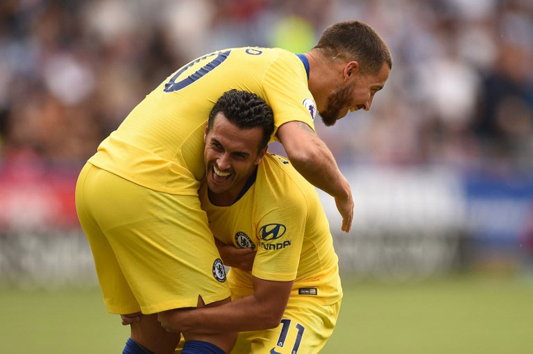 Chelsea's Spanish midfielder Pedro (R) celebrates with Chelsea's Belgian midfielder Eden Hazard after scoring the team's third goal past Huddersfield Town's English goalkeeper Ben Hamer during the English Premier League football match between Huddersfield Town and Chelsea at the John Smith's stadium in Huddersfield, northern England on August 11, 2018. PHOTO/AFP