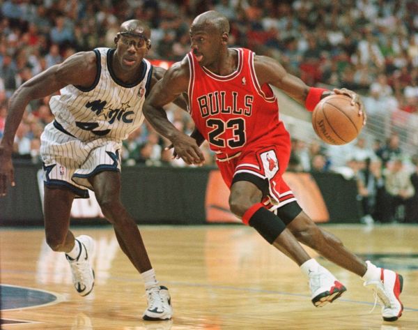 Chicago Bulls guard Michael Jordan drives past Orlando Magic forward Charles Outlaw for two points during the first period of the game at the Arena in Orlando, 25 March. PHOTO | AFP