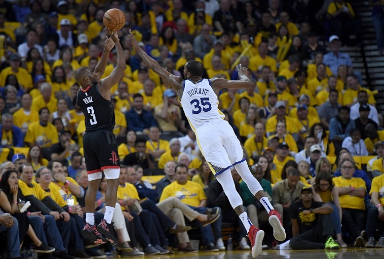 Chris Paul #3 of the Houston Rockets shoots over Kevin Durant #35 of the Golden State Warriors during Game One of the Second Round of the 2019 NBA Western Conference Playoffs at ORACLE Arena on April 28, 2019 in Oakland, California. PHOTO/AFP