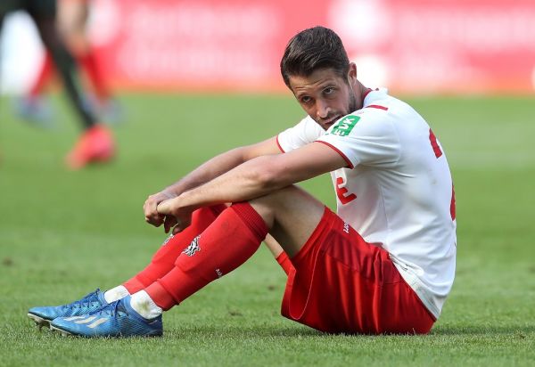 Cologne's Mark Uth sits on the grass after the game. PHOTO | AFP